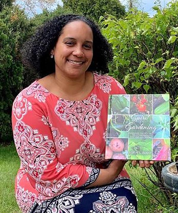 Dean Robin Avant holding a copy of her book